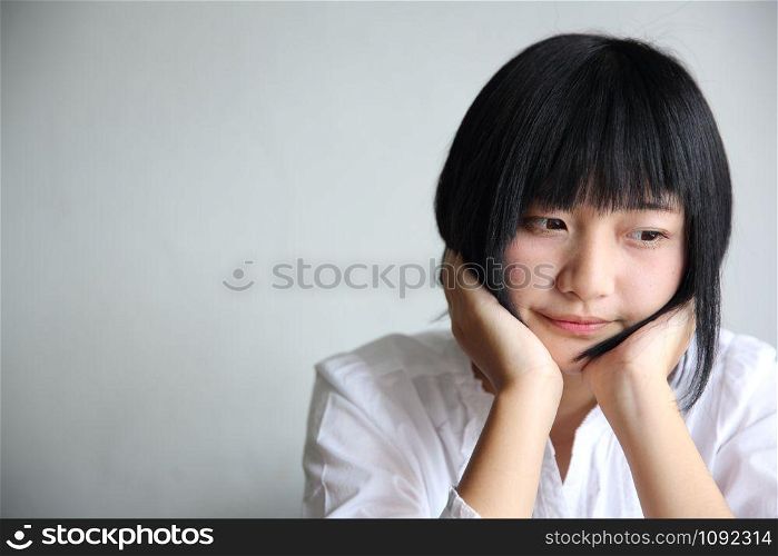 Asian young woman thinking and looking portrait in coffee shop cafe