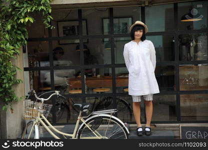 Asian young woman thinking and looking portrait with in coffee shop