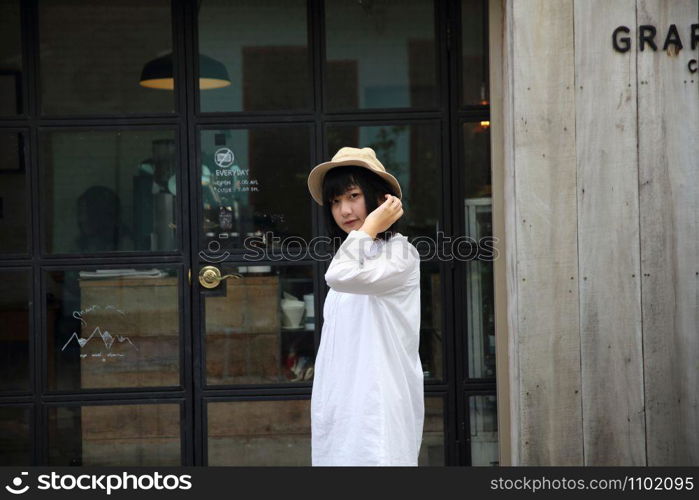 Asian young woman thinking and looking portrait with in coffee shop