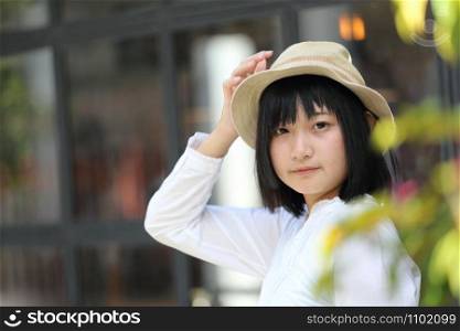 Asian young woman thinking and looking portrait with in coffee shop
