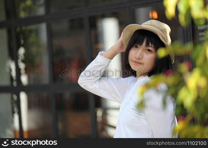 Asian young woman thinking and looking portrait with in coffee shop