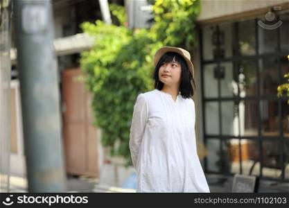 Asian young woman thinking and looking portrait with in coffee shop