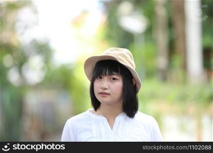Asian young woman thinking and looking travel concept portrait with green tree background
