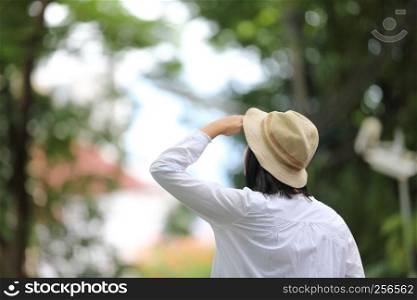 Asian young woman thinking and looking travel concept portrait with green tree background