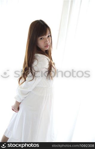 Asian young woman wake up with pillow in white room