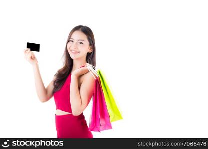 Asian young woman with red dress holding a credit card and bag paper colorful isolated on white background.