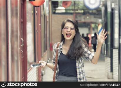 asian younger cheerful woman walking on shopping area happiness emotion