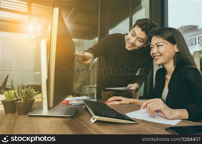 asian younger freelance man and woman working on computer at home office