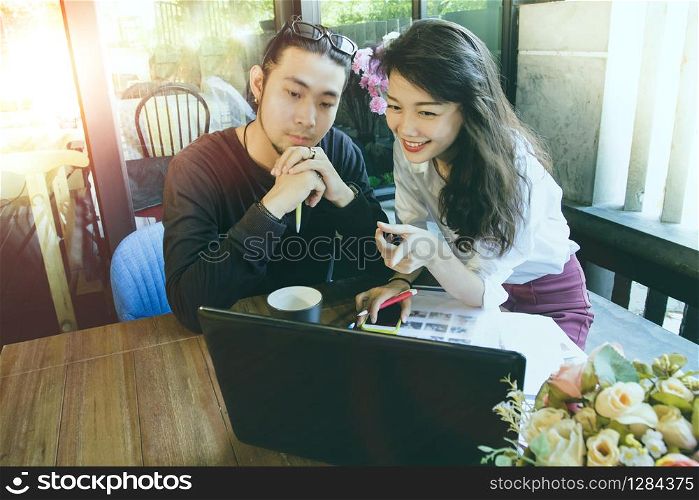 asian younger freelance man and woman working on computer in home office
