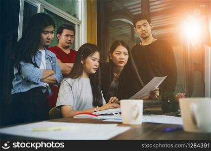 asian younger freelance team concentrate on working project in computer monitor