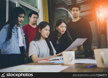 asian younger freelance team concentrate on working project in computer monitor