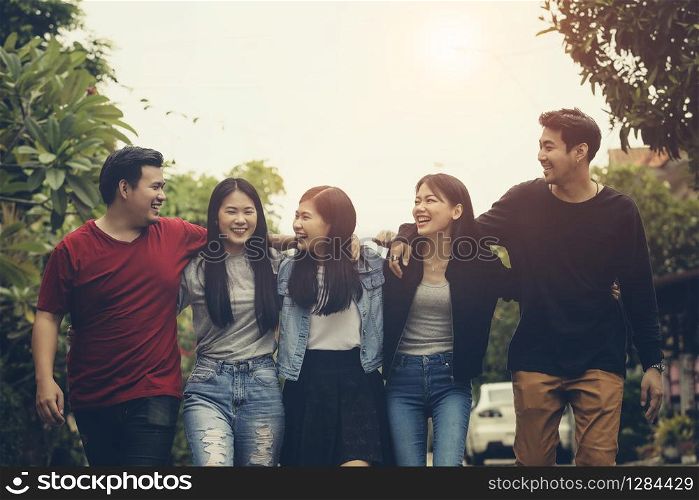 asian younger freelance team laughing with happiness after work project successful