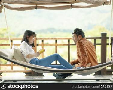 asian younger man and woman smiling face happiness emotion relaxing on cradle