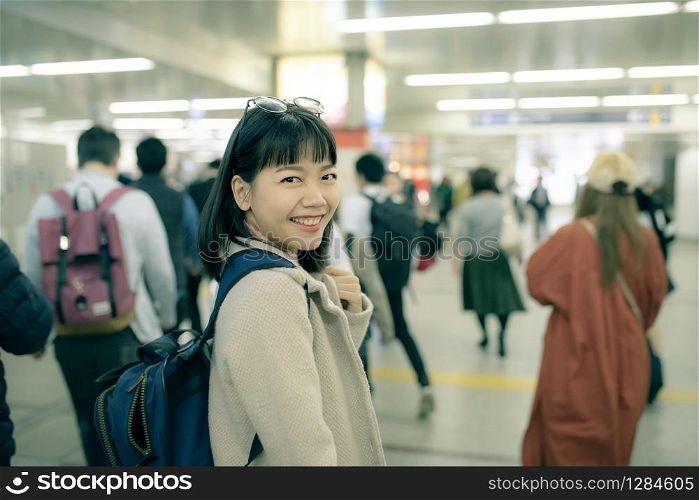 asian younger woman traveling in underground trains station of osaka japan