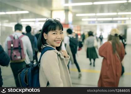 asian younger woman traveling in underground trains station of osaka japan