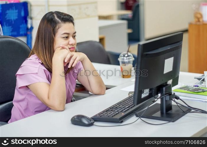 Asians women working at computer in an office.