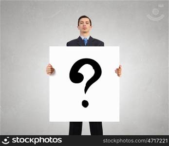 Ask your question. Young businessman showing banner with question mark