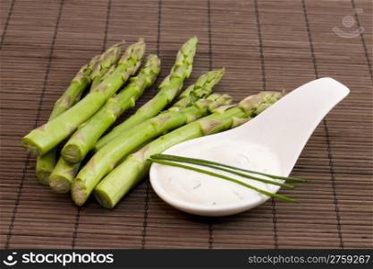 asparagus and tzatziki. a bunch of asparagus with tzatziki cream