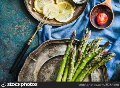Asparagus cooking preparation on rustic kitchen table, top view, close up