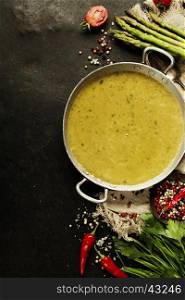 Asparagus cream soup on dark rustic background