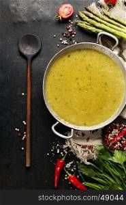 Asparagus cream soup on dark rustic background