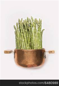 Asparagus in cooking pot on white background , front view. Healthy vegetarian food and eating concept. Spring seasonal eating
