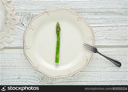 asparagus in white plate minimalist concept of raw vegetarian food