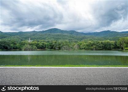 Asphalt black grey road landscape lake views at Ang Kaew Chiang Mai University in nature forest Mountain views spring blue sky background with white cloud.