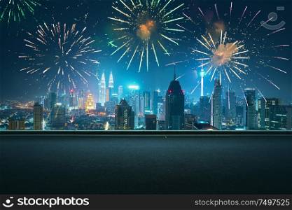 Asphalt empty road side with city skyline and firework sky background . Night scene with firework celebration .