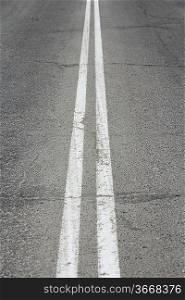 Asphalt highway with two white stripes