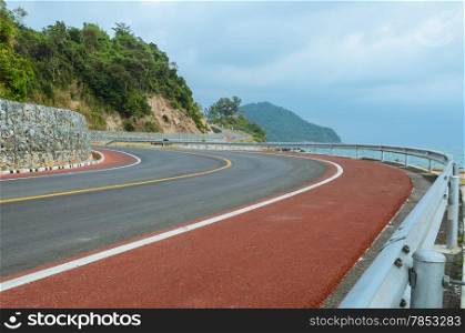 Asphalt road along a tropical sea coastline