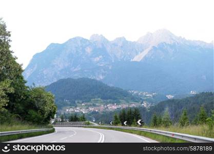 asphalt road among mountains and trees