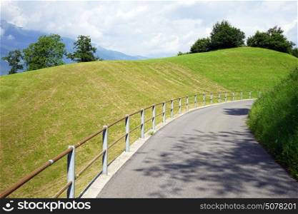 Asphalt road and farm field in Lichtenstein