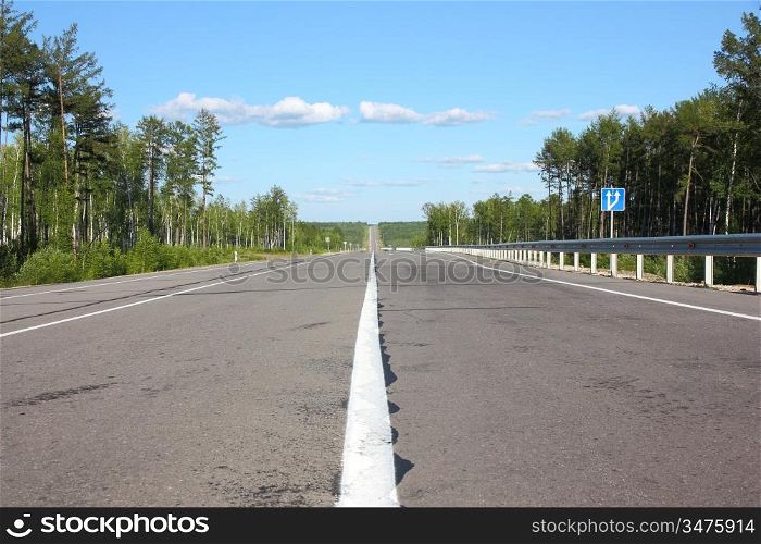 Asphalt road and sky with clouds