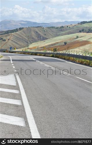 Asphalt Road between Stubble Fields of Sicily