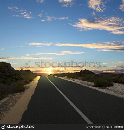 Asphalt road in countryside and cloudy sky