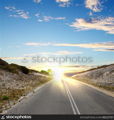Asphalt road in countryside and cloudy sky