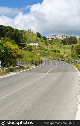 Asphalt Road Leading to the City on the Hills in Sicily