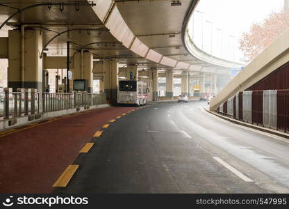 asphalt road under the overpass with a dedicated line for public transpor.. asphalt road under the overpass with a dedicated line for public transport