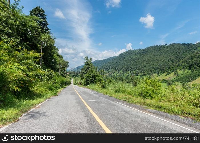 Asphalt road with green mountain landscape
