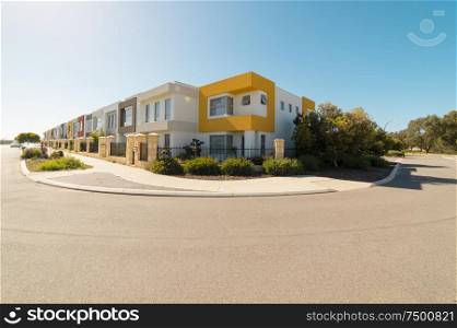 Asphalt road with modern terrace house in front on blue sky background. Yanchep Beach Town , Perth , Western Australia .
