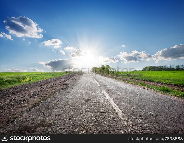 Asphalted highway in the field and sunlight