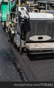Asphalting machine on the road. Close up