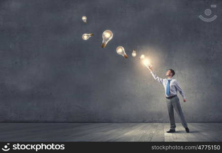 Aspiration for knowledge. Young businessman standing with opened book in hand