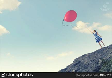 Aspiration to freedom. Young elegant woman trying to reach sky
