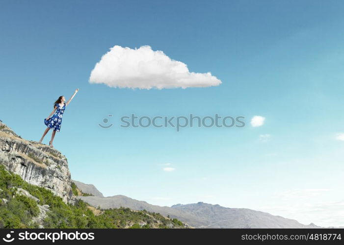 Aspiration to freedom. Young elegant woman trying to reach sky