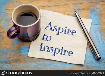 aspire to inspire - handwriting on a napkin with a cup of espresso coffee