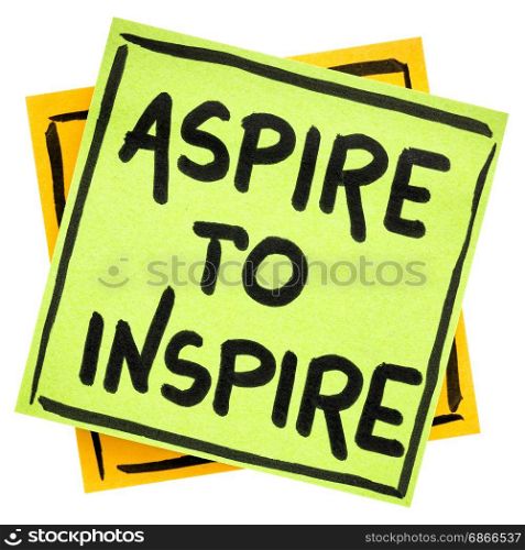 aspire to inspire reminder - handwriting in black ink on an isolated sticky note