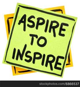 aspire to inspire reminder - handwriting in black ink on an isolated sticky note