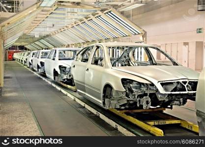 assembled cars in a row at car plant